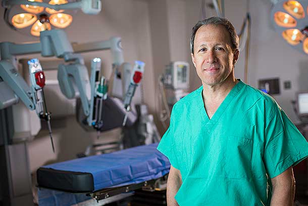 A surgeon standing in front of the da Vinci surgical system