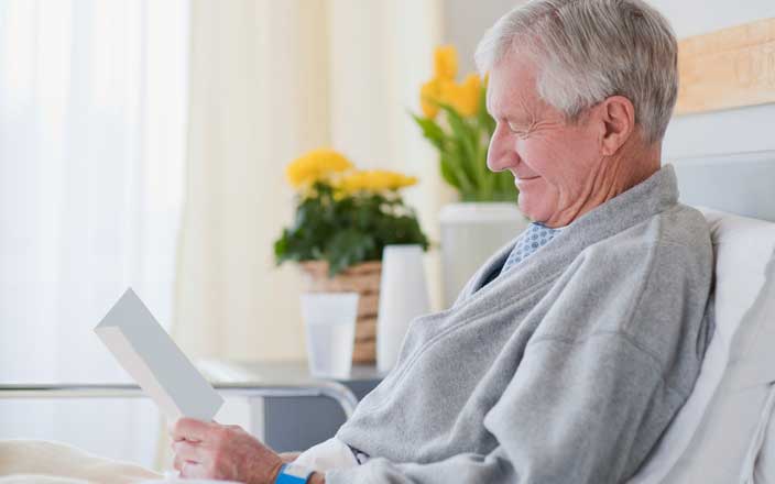 Smiling man reading a note