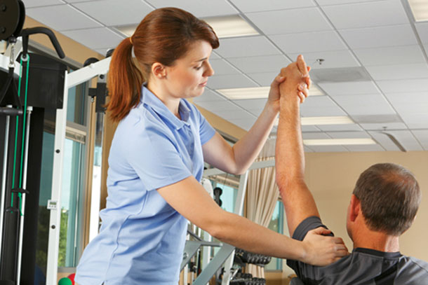 A male patient receiving physical therapy