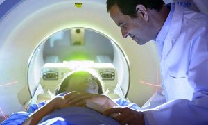 doctor reassuring patient in CT Scanner