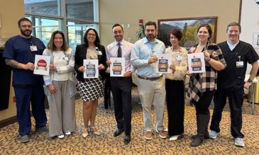 NNMC staff members holding the awards