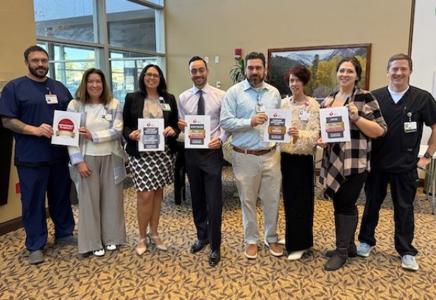 NNMC staff members holding the awards