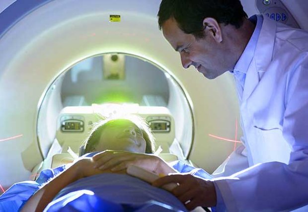 doctor reassuring patient in CT Scanner