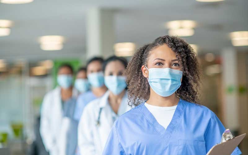 Healthcare staff with masks, lined up