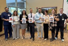 NNMC staff members holding the awards