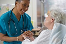 A nurse comforting a patient