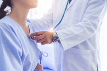 Doctor checking the heart of a female patient