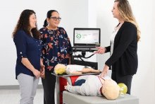 An instructor teaching students CPR