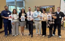 NNMC staff members holding the awards