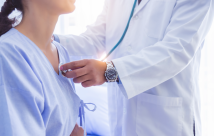 Doctor checking the heart of a female patient