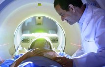 doctor reassuring patient in CT Scanner